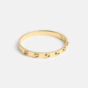 COACH® Pegged Signature Hinged Bangle Women Jewelry Gold | BUAN83027